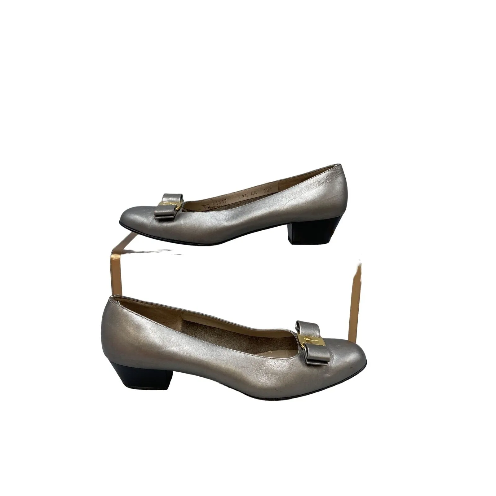 Ferragamo silver leather, 1 inch wood stacked heel, slip-on Vara flats with a 3 inch wide, embellished bow at toe with gold tone hardware